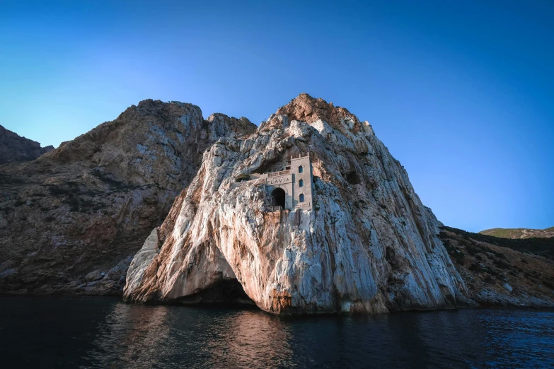 a rock formation in the middle of a body of water, by Matteo Pérez, pexels contest winner, baroque, whitewashed housed, piroca, apollinaris vasnetsov, 2 0 0 0's photo