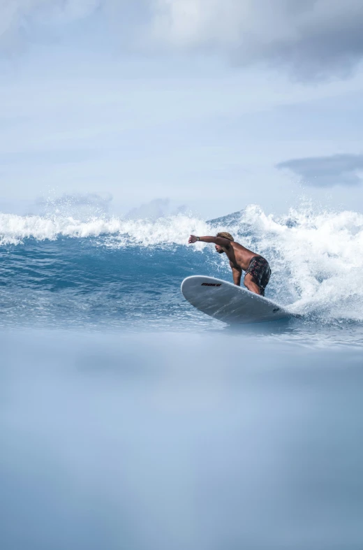 a woman riding a wave on top of a surfboard, reefs, shot with sony alpha, high-quality photo, rectangle