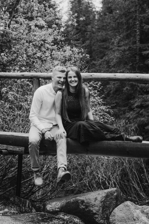 a black and white photo of a couple sitting on a bridge, a black and white photo, by Anato Finnstark, realism, in the wood, happy and smiling, 15081959 21121991 01012000 4k, 🌸 🌼 💮