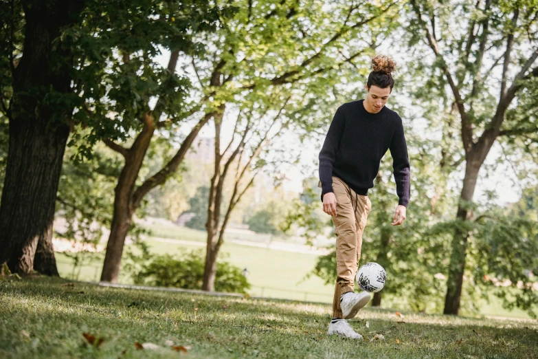 a man kicking a soccer ball in a park, by Julia Pishtar, wearing cargo pants, avatar image, lifestyle, thumbnail