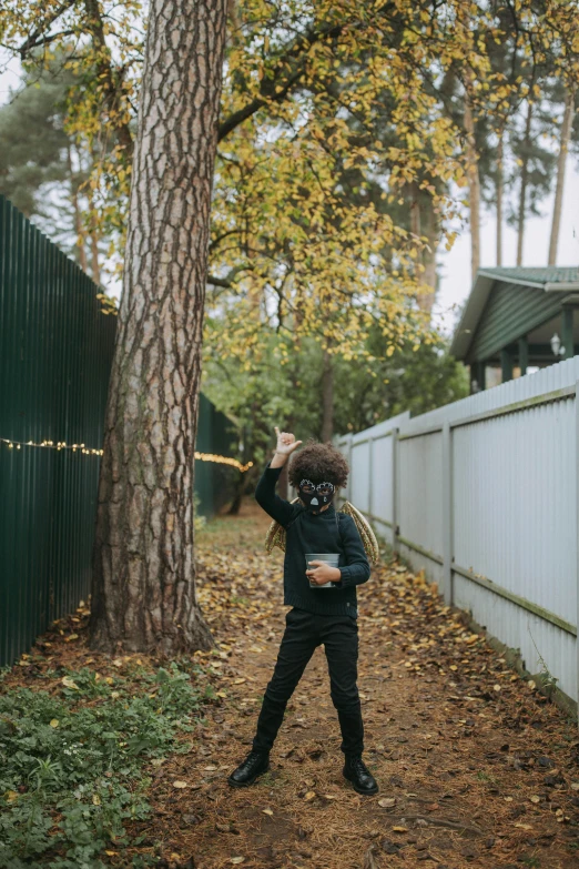 a person taking a picture of a tree with a camera, an album cover, by Attila Meszlenyi, unsplash, graffiti, little kid, scary pines, 🍂 cute, fencing