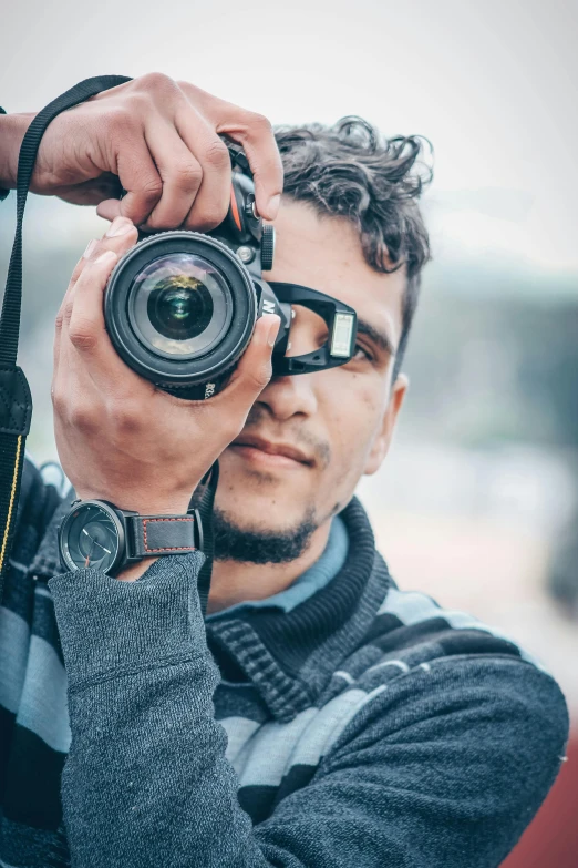 a man taking a picture with a camera, body and headshot, mohamed chahin, face focused, telephoto