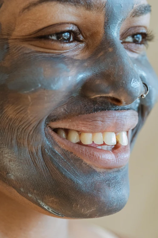 a close up of a person with a face mask, brown skin man with a giant grin, charcoal skin, wax skin, face and body clearly visible