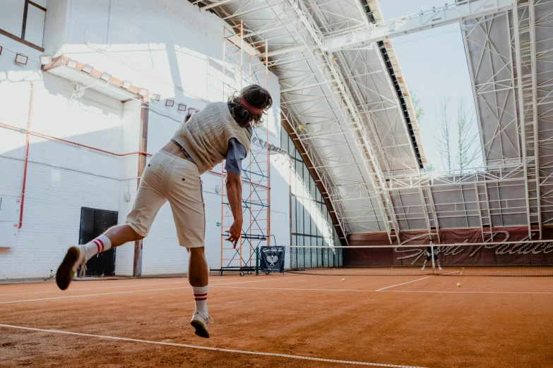 a man standing on top of a tennis court holding a racquet, inspired by Hans Mertens, pexels contest winner, happening, terracotta, full body 8k, indoor picture, mid action swing