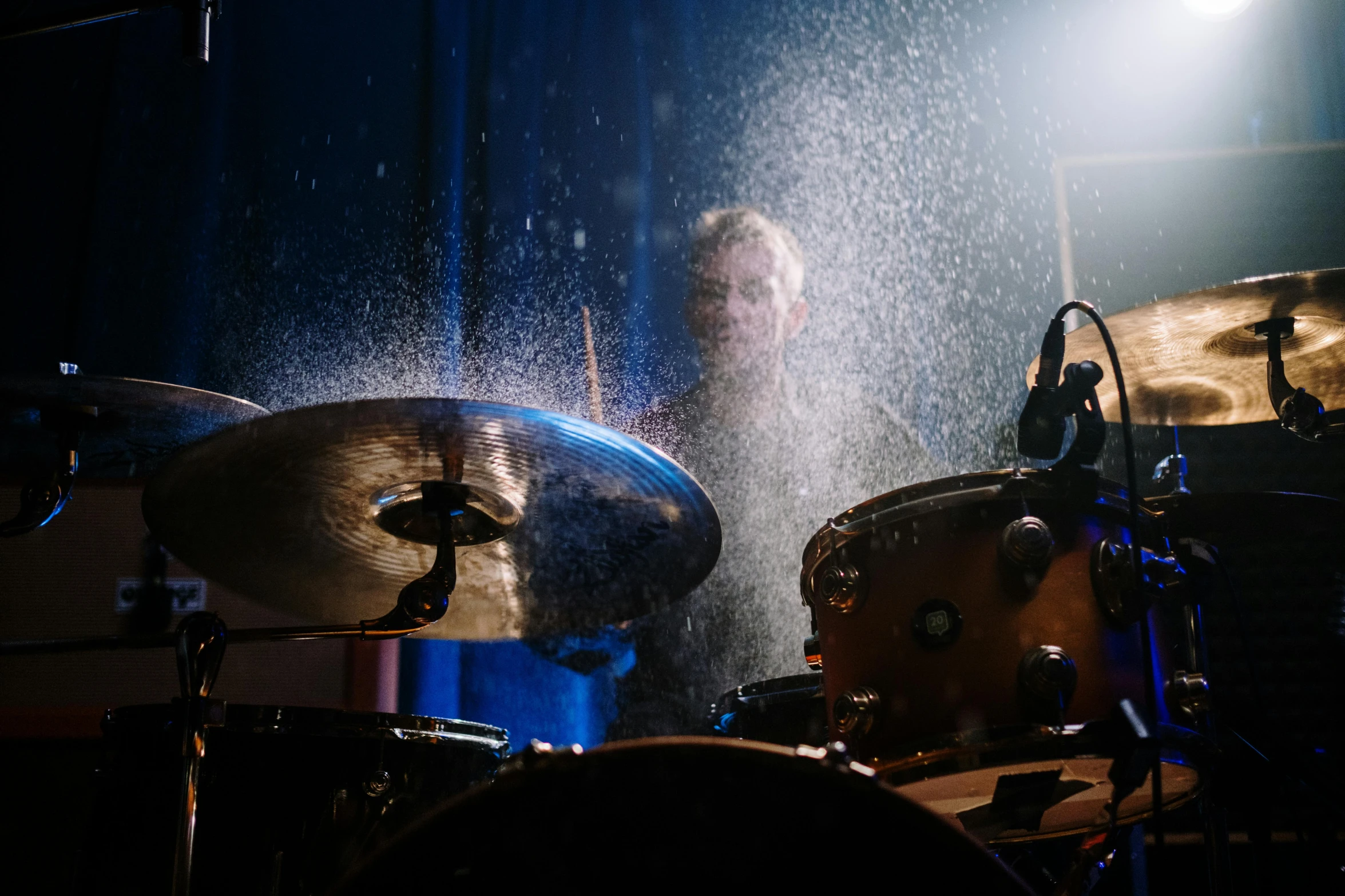 a man playing drums in a dark room, by Julia Pishtar, pexels contest winner, process art, covered in water drops, concert, avatar image, solid background