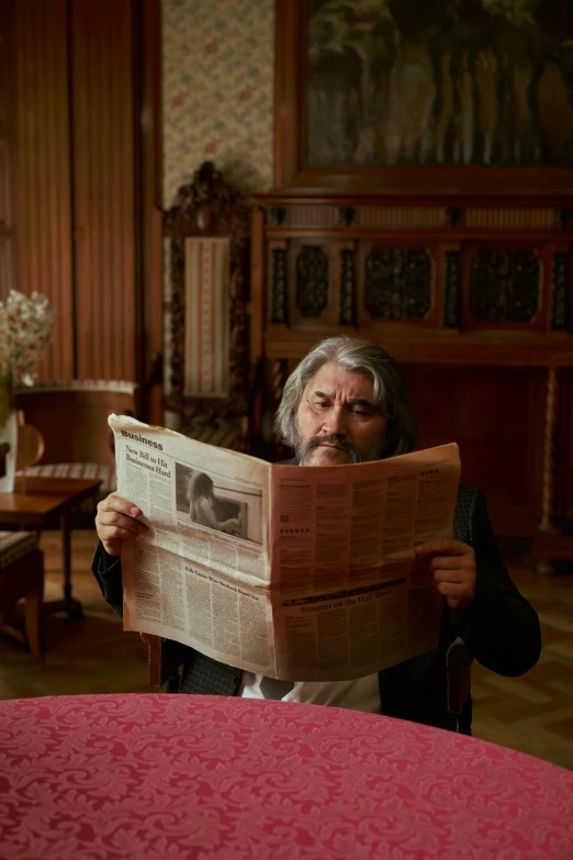 a man reading a newspaper in a living room, by Adriaen Hanneman, trending on reddit, slavoj zizek, scene from live action movie, rasputin, a silver haired mad