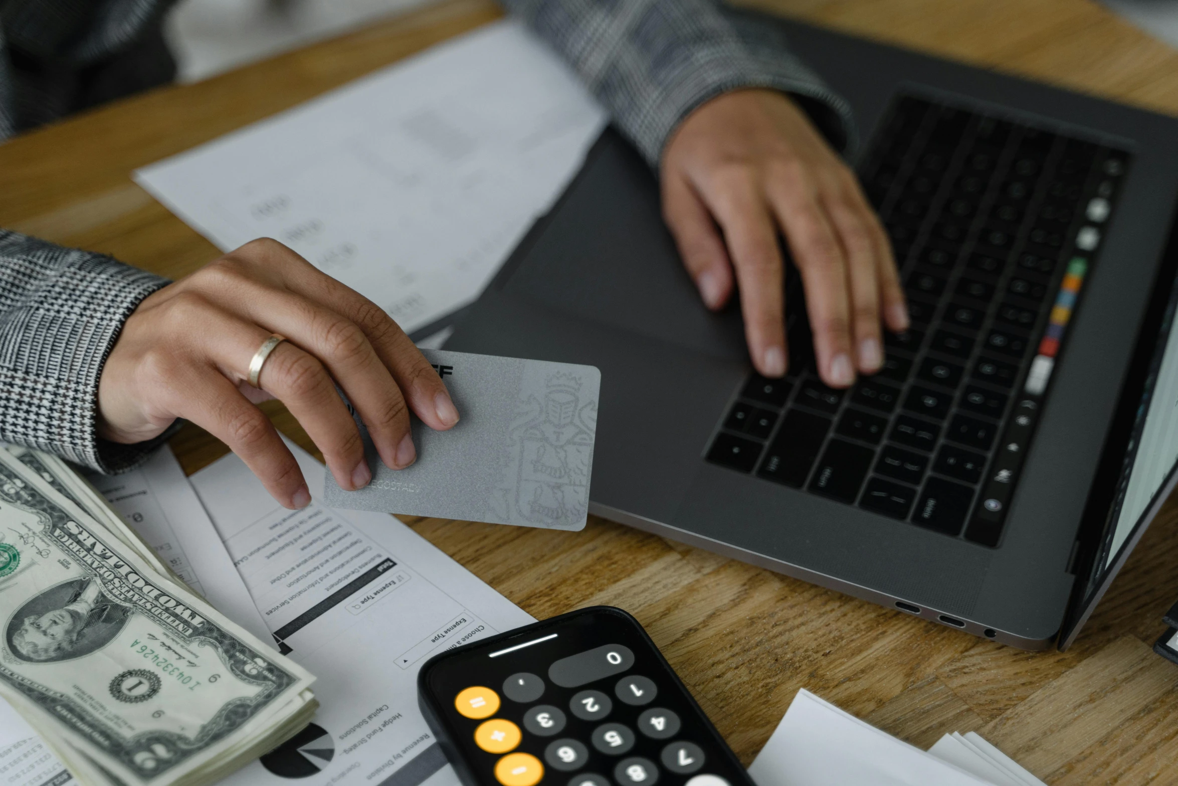 a person sitting at a desk with a laptop and a calculator, a screenshot, pexels contest winner, hurufiyya, cost, 15081959 21121991 01012000 4k, brown, realistic »