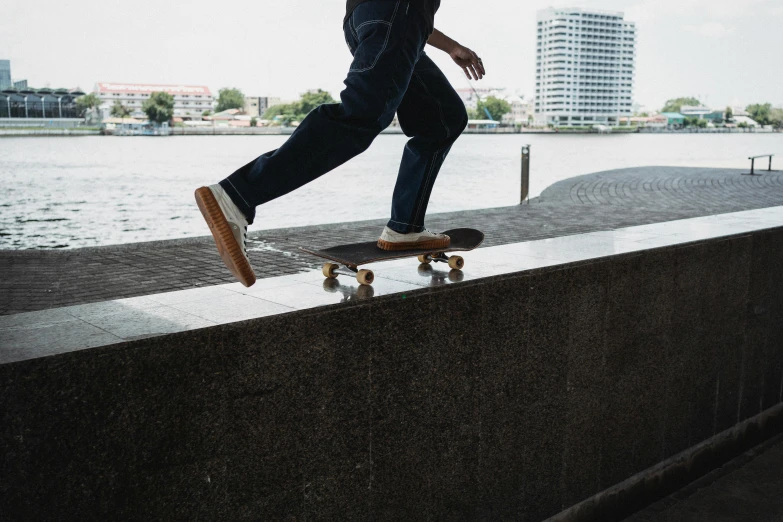 a man riding a skateboard down the side of a wall, pexels contest winner, at the waterside, standing on a desk, 15081959 21121991 01012000 4k, gum rubber outsole