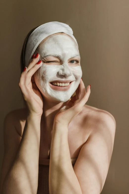 a woman with a facial mask on her face, trending on pexels, renaissance, with a happy expression, porcelain pale skin, playful, covered in