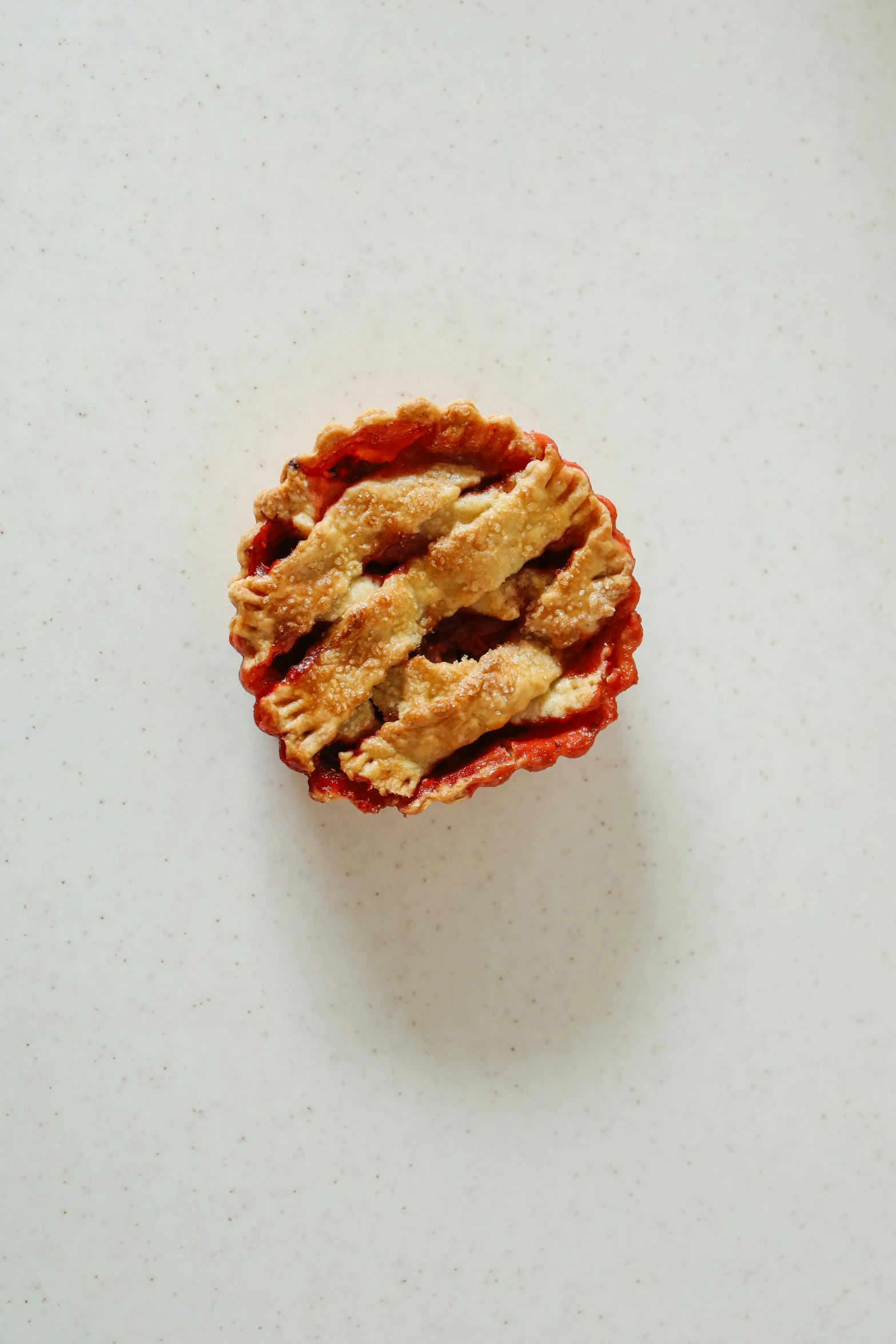 a piece of pie sitting on top of a table, product image, vermillion, mini, organic