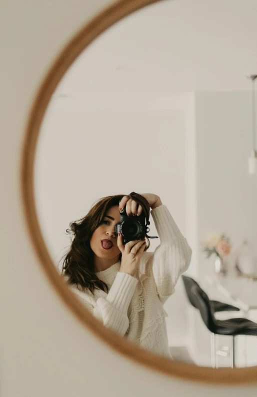 a woman taking a picture of herself in a mirror, pexels contest winner, wearing a white sweater, low quality photo, gif, minimalist photo