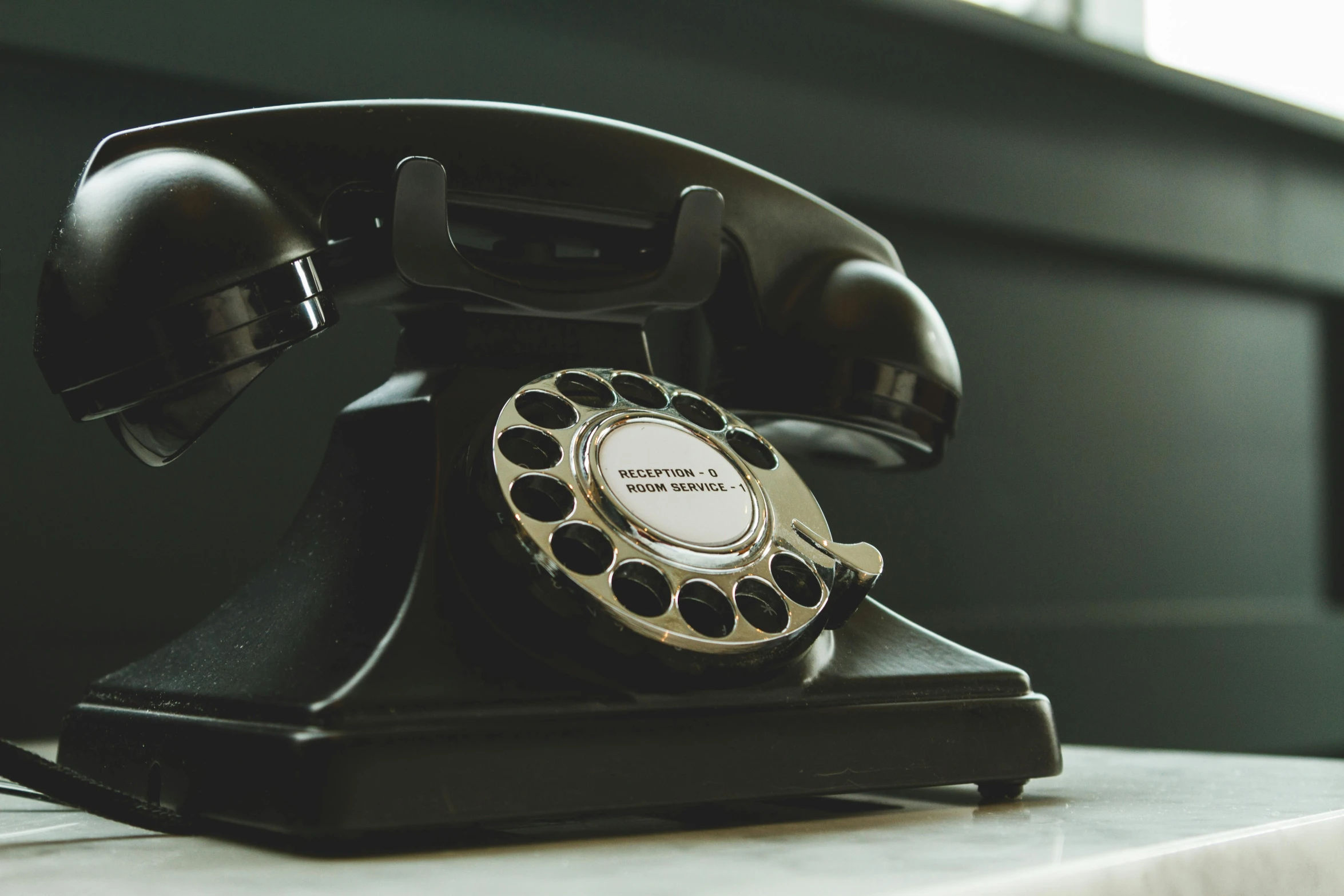 a black telephone sitting on top of a table, unsplash, vintage closeup photograph, 15081959 21121991 01012000 4k, replica model, the ring