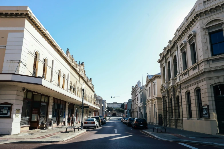 a city street filled with lots of tall buildings, renaissance, white pale concrete city, victoria, preserved historical, driving through a 1 9 5 0 s town