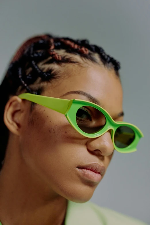 a woman wearing green sunglasses and a green jacket, inspired by Esaias Boursse, trending on pexels, ashteroth, with fluo colored details, avatar image, zoomed out view