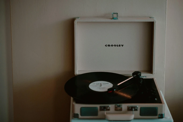 a record player sitting on top of a table, an album cover, by Carey Morris, trending on pexels, chesley, johnny craig, glossy white metal, thumbnail