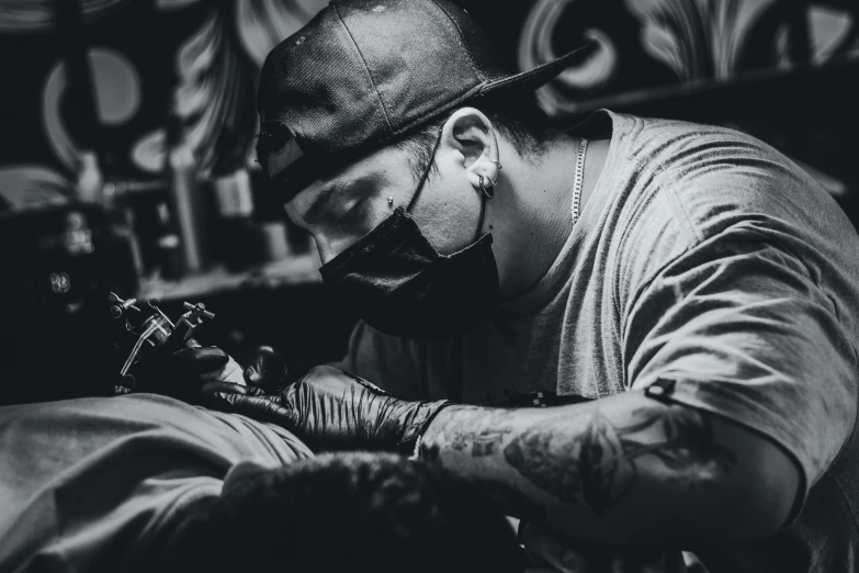 a man getting a tattoo on his arm, a tattoo, by Adam Marczyński, pexels contest winner, process art, white man with black fabric mask, working hard, profile picture 1024px, avatar image