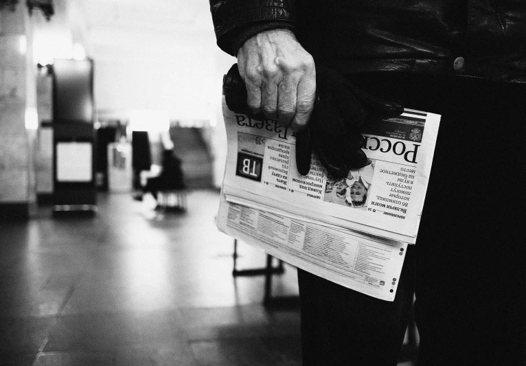 a black and white photo of a person holding a newspaper, by Matija Jama, pexels, elderly, underground, 15081959 21121991 01012000 4k, instagram post