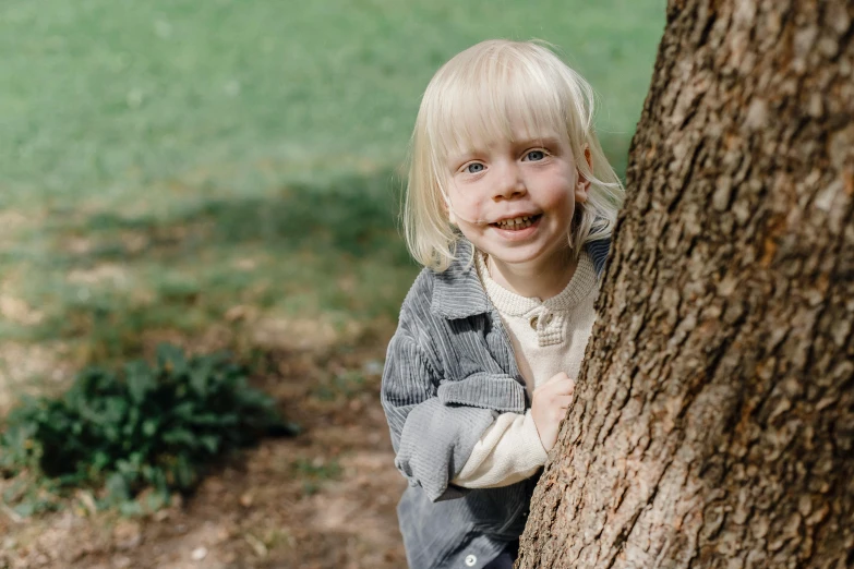 a little girl peeking out from behind a tree, a picture, by Lee Loughridge, pexels contest winner, small blond goatee, lachlan bailey, portrait of billie eilish, 15081959 21121991 01012000 4k