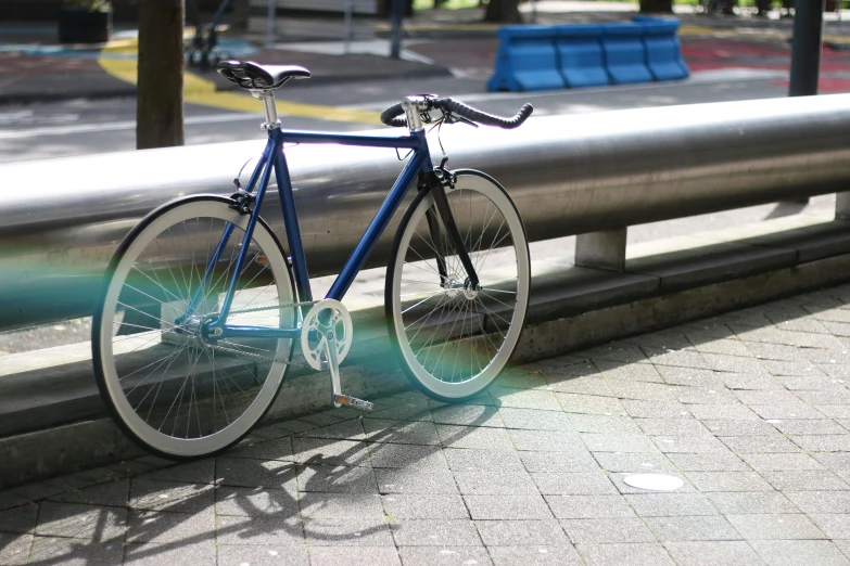 a blue bicycle parked on the side of a road, slightly holographic, standing under a beam of light, in tokio, stealthy