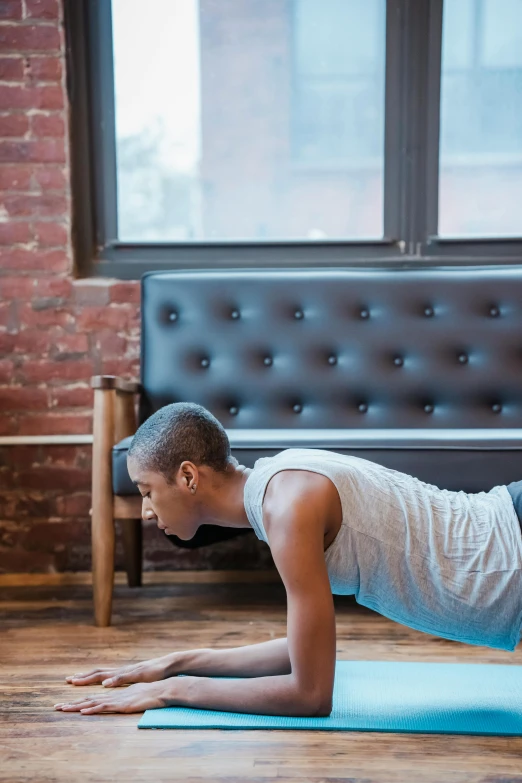 a man doing push ups on a yoga mat, by Everett Warner, trending on unsplash, renaissance, jamel shabazz, thin young male, “ full body, profile image