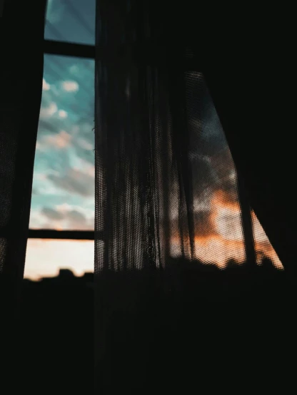 a silhouette of a person standing in front of a window, inspired by Elsa Bleda, unsplash contest winner, magical realism, cloudy sunset, ethereal curtain, ☁🌪🌙👩🏾, picture of a loft in morning