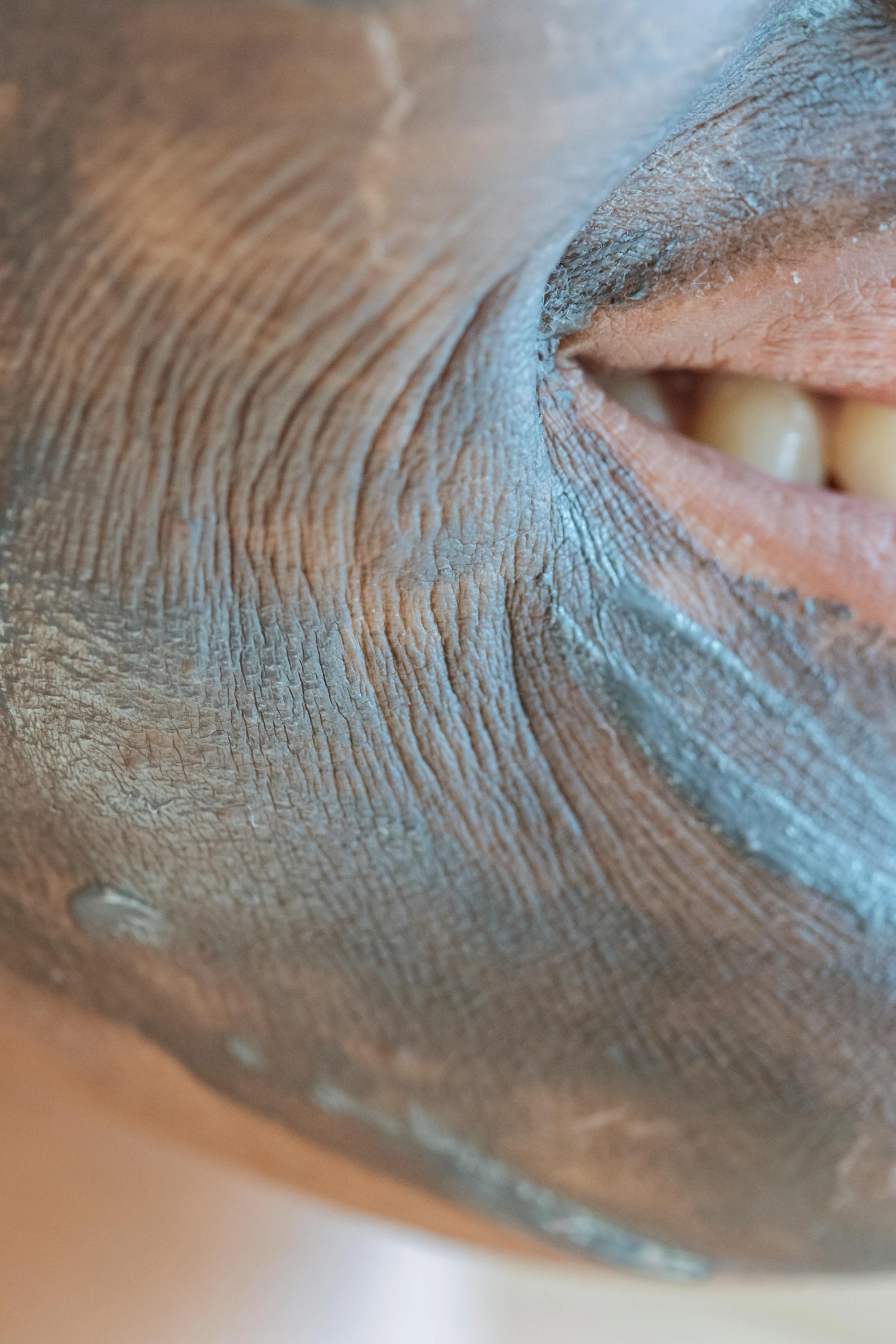 a close up of a person's face with a mask on, gaping gills and baleen, blue chrome top hippo body, mole on cheek, a plaster on her cheek