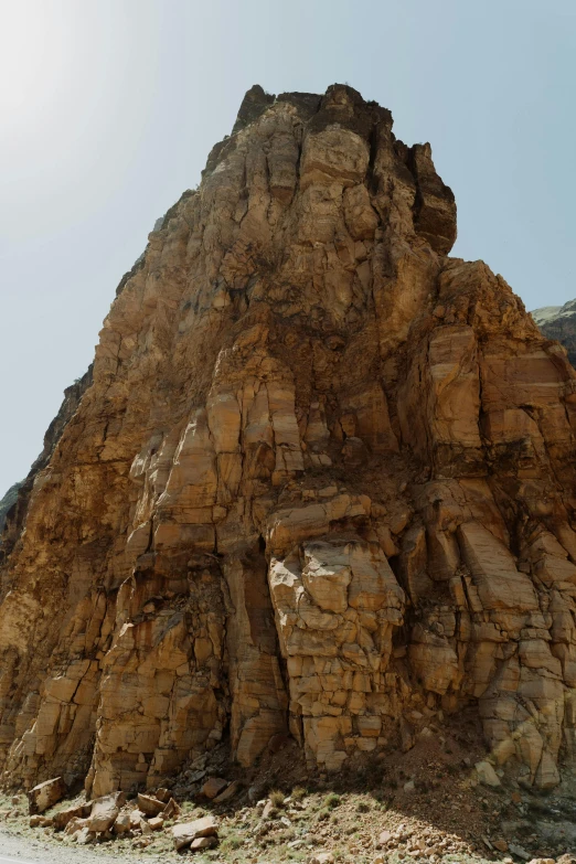 a man riding a motorcycle down a dirt road, les nabis, extremely detailed rocky crag, ((monolith)), zoomed in, structural geology