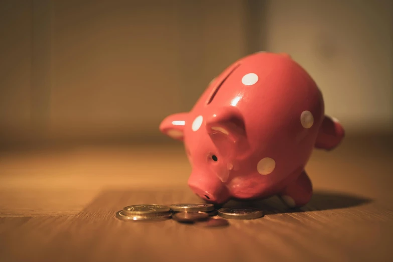 a pink piggy bank sitting on top of a pile of coins, by Adam Marczyński, pexels contest winner, lo fi, rain lit, 15081959 21121991 01012000 4k, on a wooden table