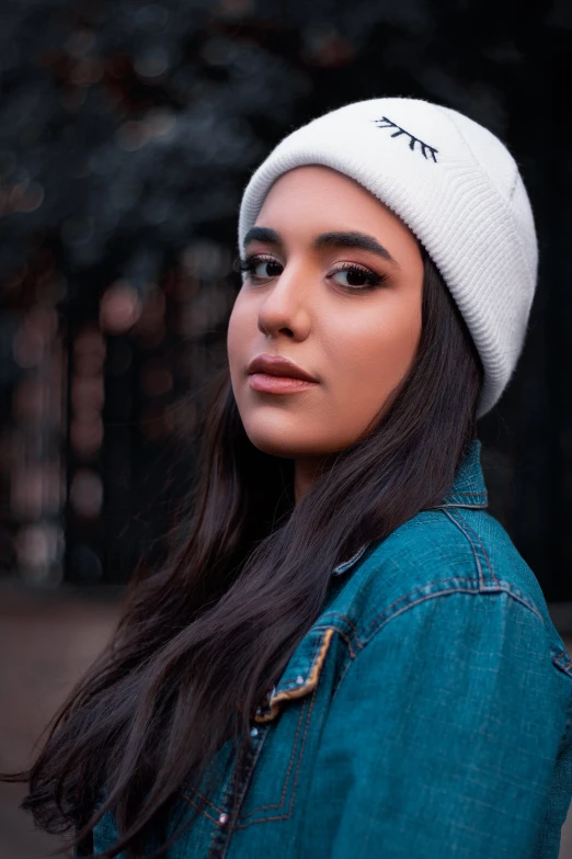 a woman with long black hair wearing a white beanie, inspired by Elsa Bleda, trending on pexels, promotional image, teenager girl, indian, 5 5 mm photo