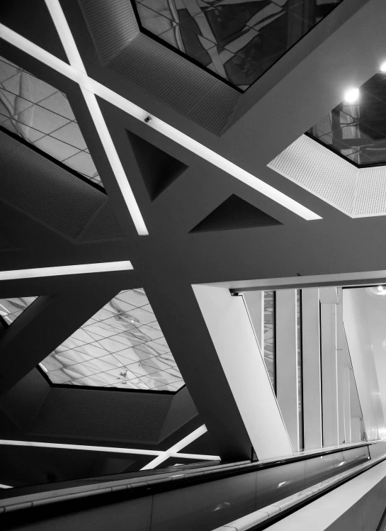 a black and white photo of an escalator, inspired by Vassily Maximov, pexels contest winner, light and space, office ceiling panels, square lines, angular design, symmetry! futuristic robotic