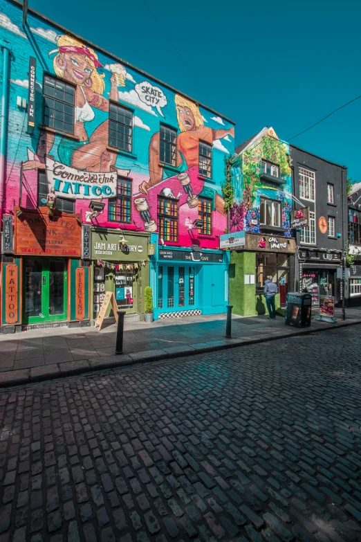 a city street filled with lots of colorful buildings, graffiti, ireland, square, colorful image, medium - shot