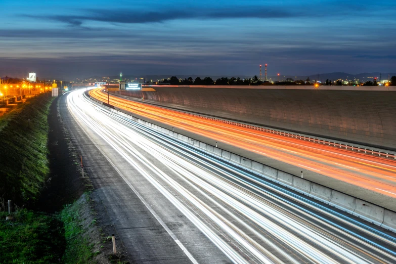 a long exposure photo of a highway at night, a picture, unsplash, visual art, blue hour lighting, thumbnail, multicoloured, composite