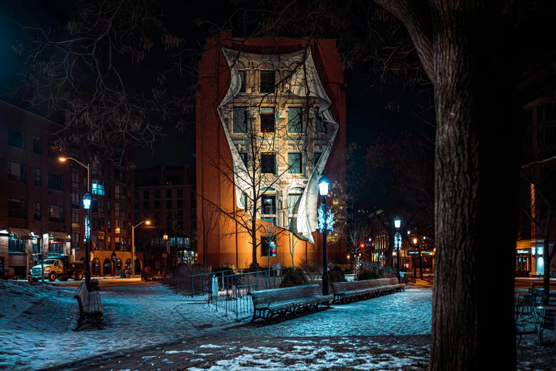 a city street at night with a clock tower in the background, a photo, by Adam Marczyński, street art, collapsed brutalist architecture, quebec, panoramic, a cozy