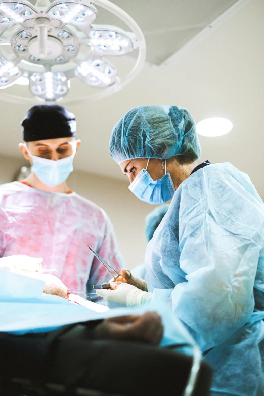 two surgeons working on a patient in an operating room, by Meredith Dillman, shutterstock, in australia, instagram story, lgbtq, tiny waist