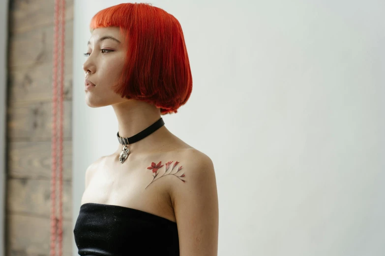a woman with red hair wearing a black dress, a tattoo, inspired by Taro Yamamoto, trending on pexels, kiko mizuhara, orange halter top, lily frank, temporary tattoo