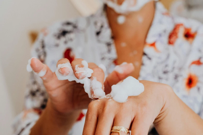 a woman in a floral shirt is shaving her hands, trending on pexels, foamy bubbles, white foam, avatar image, family friendly