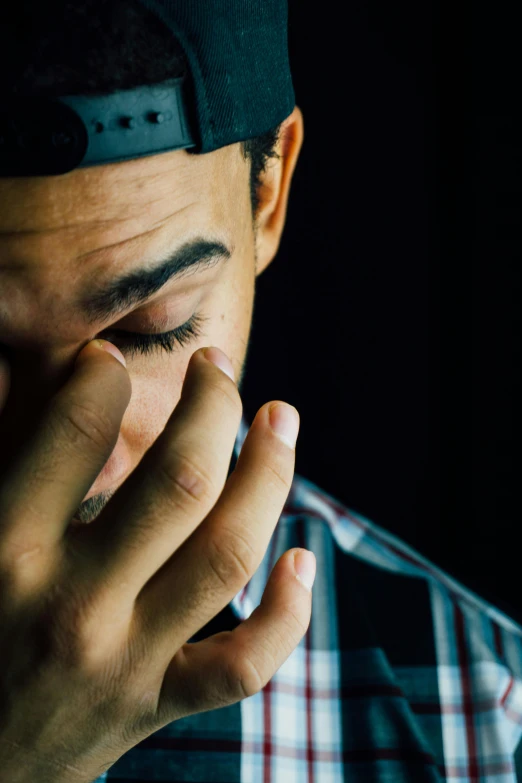 a man covers his eyes with his hands, by Robbie Trevino, pexels, movie still of a tired, godly, slide show, with a hurt expression