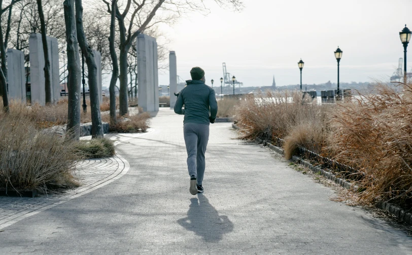 a person riding a skateboard down a street, pexels contest winner, on liberty island, working out, walking at the park, 🚿🗝📝