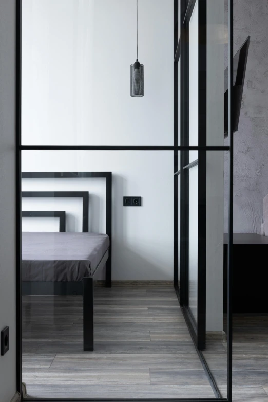 a view of a bedroom through a glass door, by Harvey Quaytman, pexels contest winner, modernism, black lacquer, beds, geometric, neotraditional modern minimalist