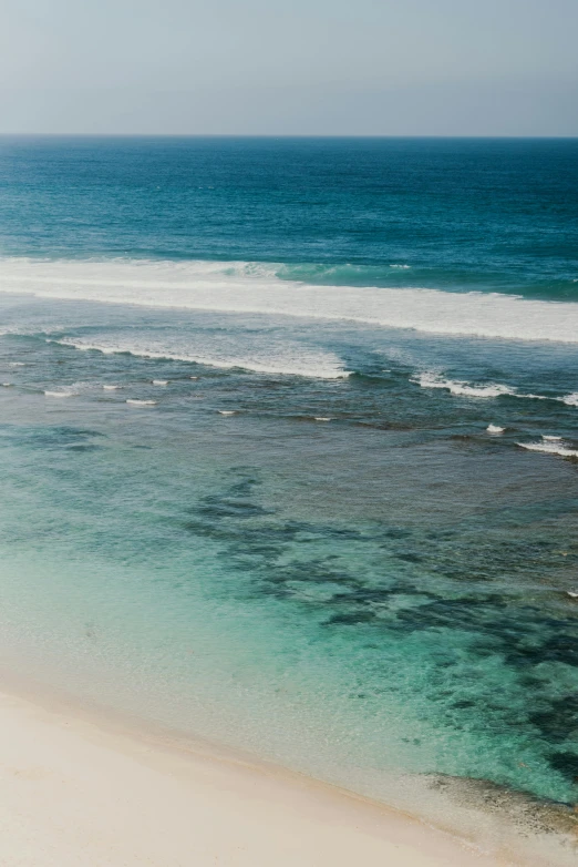 a man riding a surfboard on top of a sandy beach, reefs, as far as the eye can see, bali, slide show