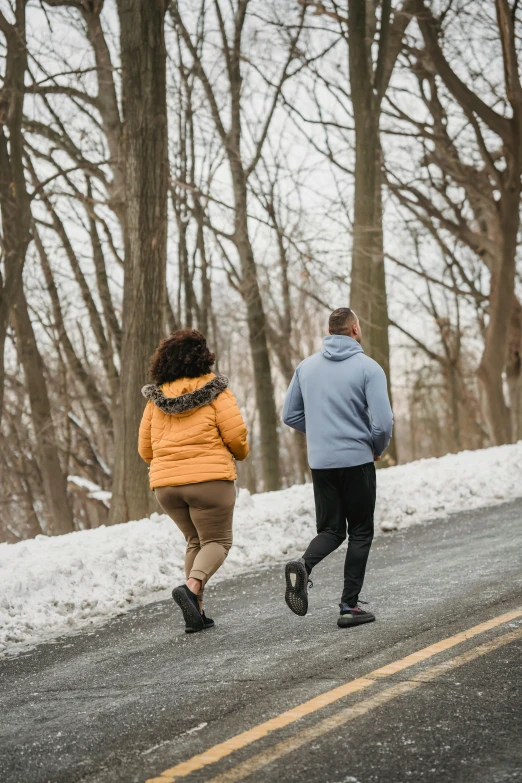 a couple of people that are running in the snow, by David Palumbo, person, roadside, cottagecore!! fitness body, brown