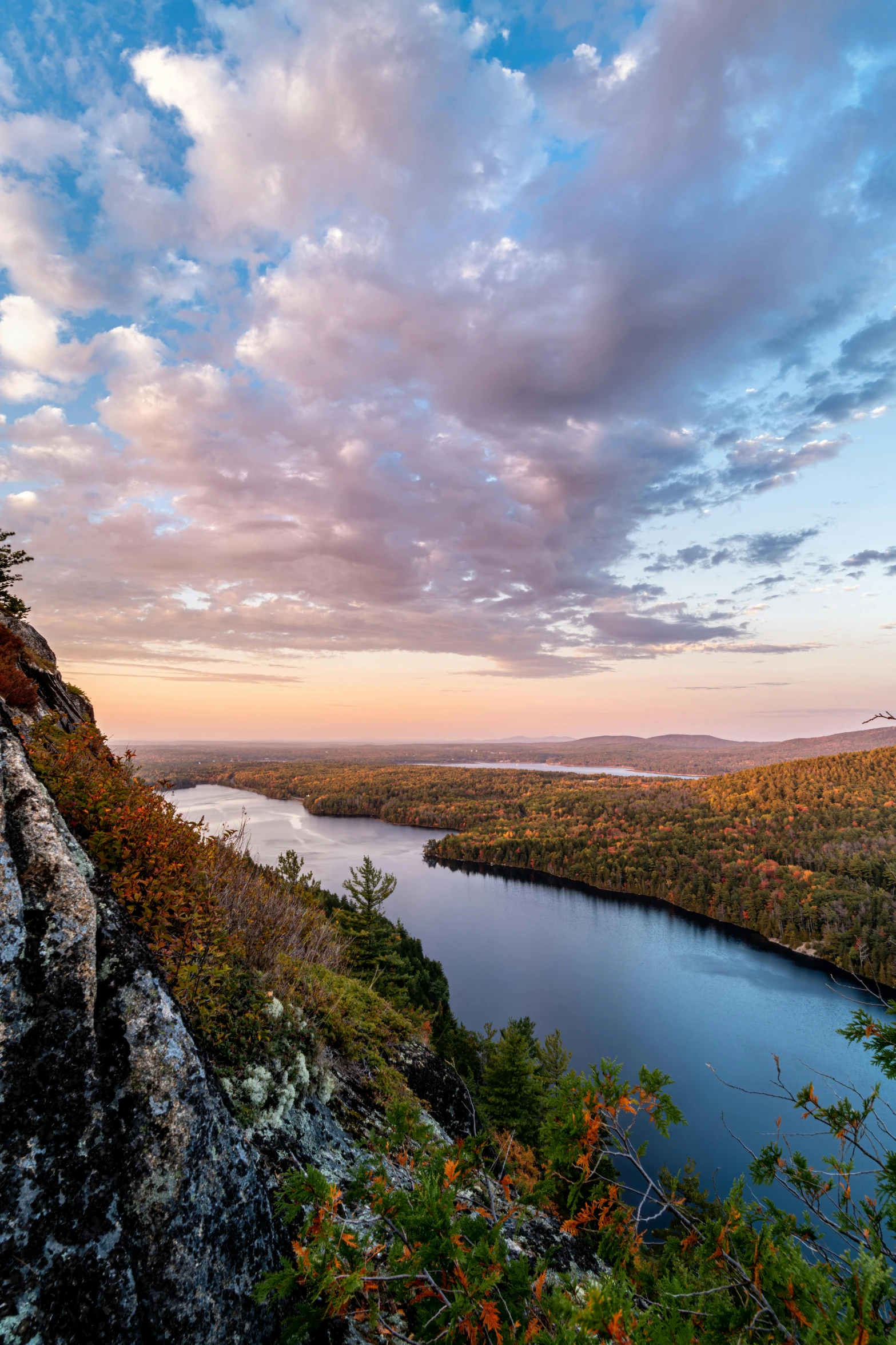 a large body of water sitting on top of a lush green hillside, unsplash contest winner, hudson river school, autumn sunset, minn, slide show, looking down a cliff