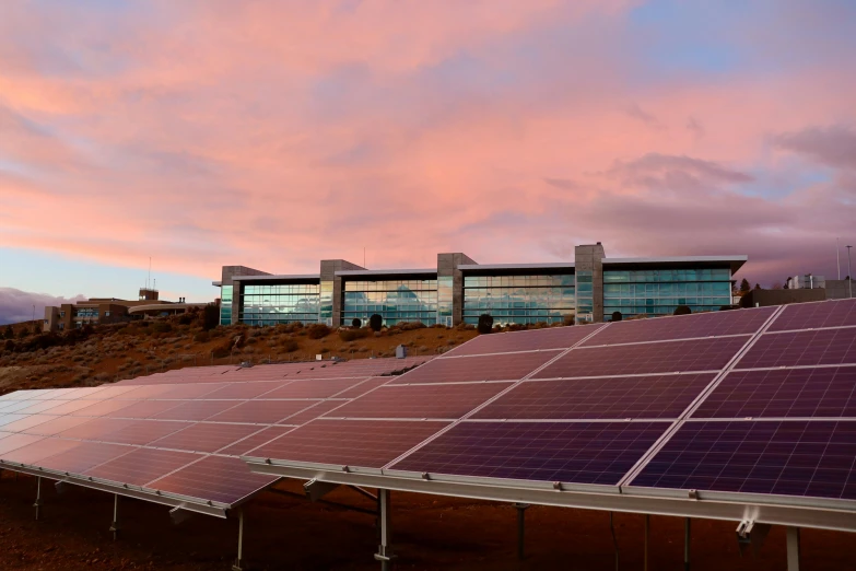 a group of solar panels sitting on top of a field, a digital rendering, by Carey Morris, unsplash, happening, inside a science facility, twilight ; wide shot, rafeal albuquerque, research complex