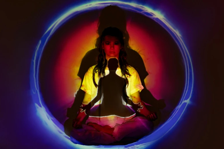 a woman sitting in the middle of a circle, a hologram, inspired by David LaChapelle, purple and yellow lighting, buddhist, glowing light and shadow, press shot