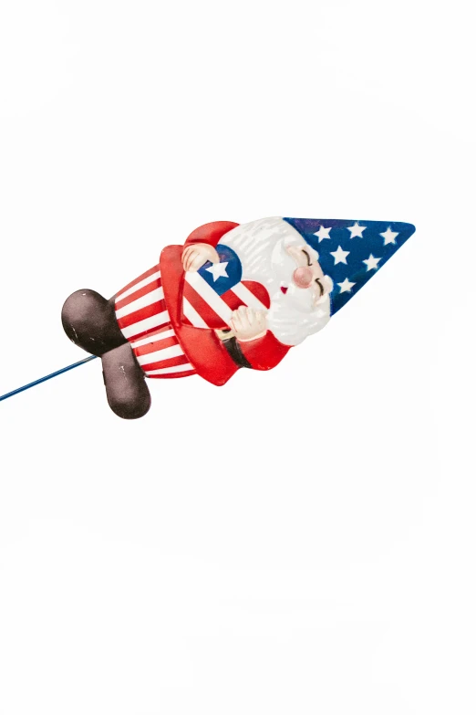 a kite shaped like a gnome flying in the sky, a cartoon, by John Backderf, stars and stripes, candy decorations, medium, image