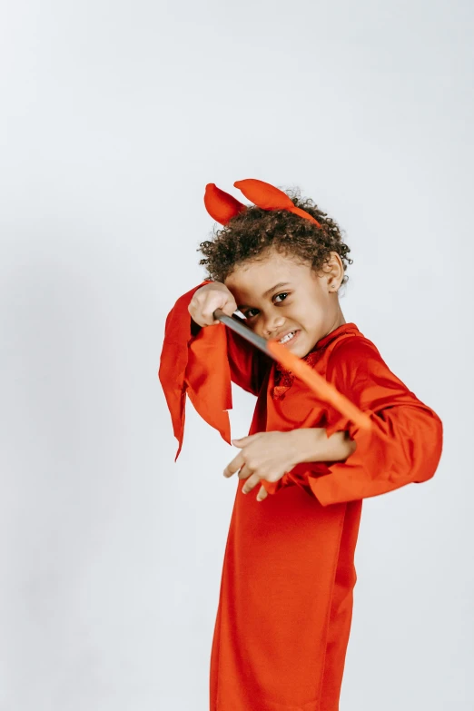 a little boy dressed in a lobster costume, an album cover, pexels contest winner, antipodeans, an evil sword, devil versus angel, toy commercial photo, diverse costumes