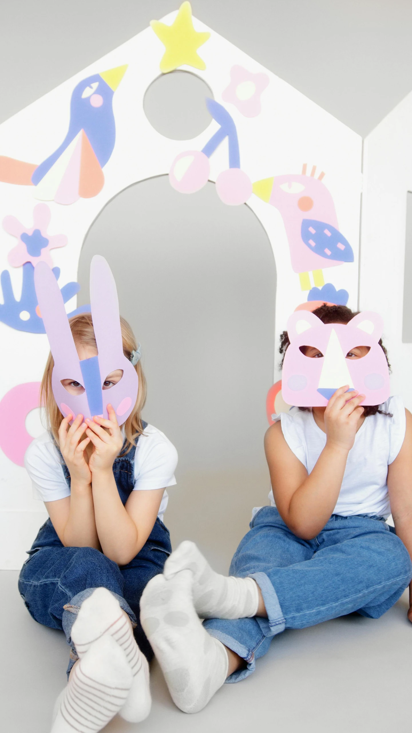 a couple of little girls sitting next to each other, a cartoon, pexels, interactive art, wearing giant paper masks, photoshoot for skincare brand, mirrors, bright fauna