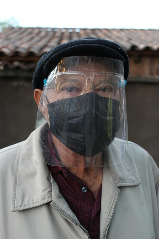 an older man wearing a protective face mask, by Bernie D’Andrea, reddit, quechua, wearing translucent veils, slide show, in spain