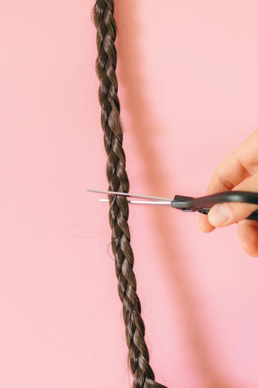 a close up of a person holding a pair of scissors, loose braided hair, full width, rectangle, uncrop