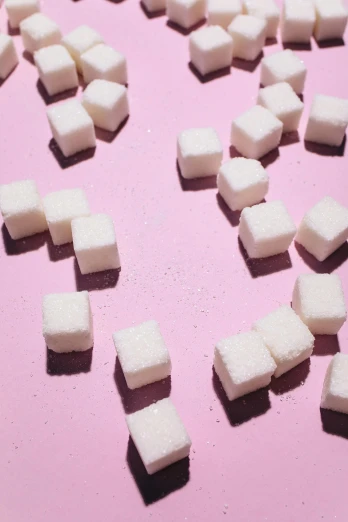 a pile of sugar cubes on a pink surface, an album cover, pexels, square lines, food, photographed for reuters, white
